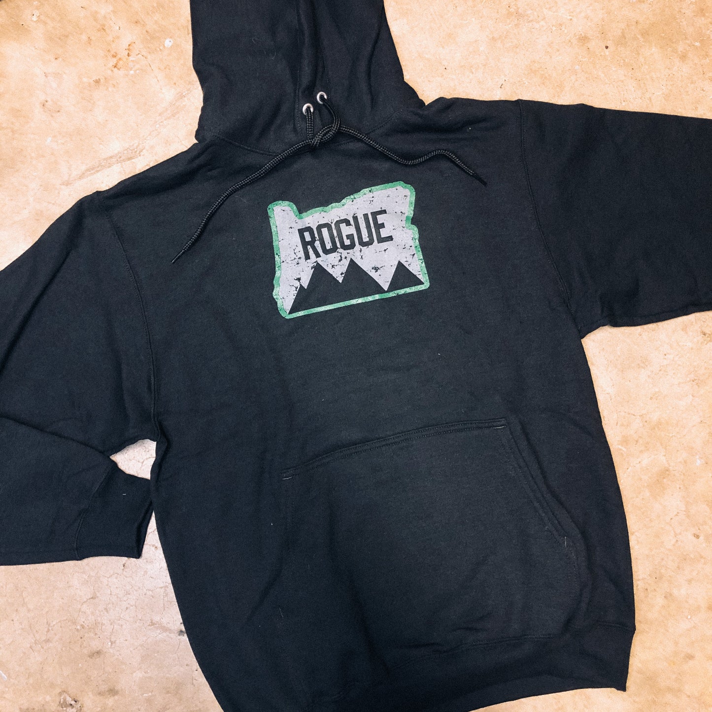 A black hooded sweatshirt with the 'ROGUE' brand logo on the front.